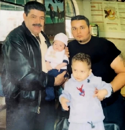 Right: Sergio Gutierrez Jr being held by his father, Sergio Sr.  Left: Holding a baby is Sergio Jr's grandfather, Sergio Sr's stepfather, Salvador Hernandez